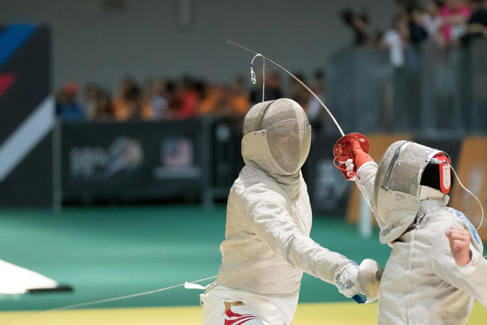 two person fencing inside the gym